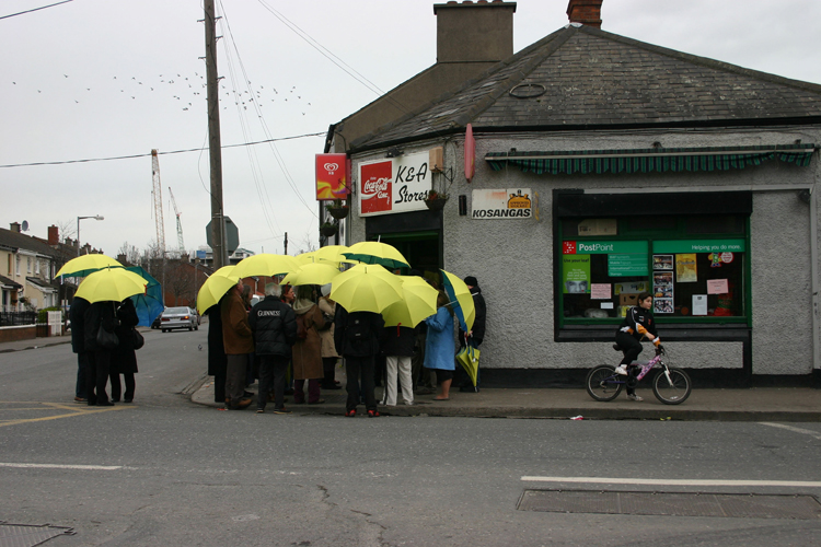  photograph - group of people on street - yellow umbrellas - The Umbrella Project, The Umbrella Project (aerial view) - Rhona Byrne - 2006